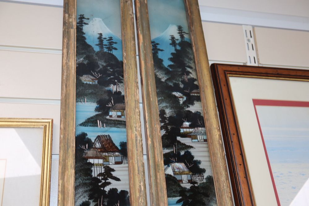 A pair of Japanese reverse painted glass panels, framed